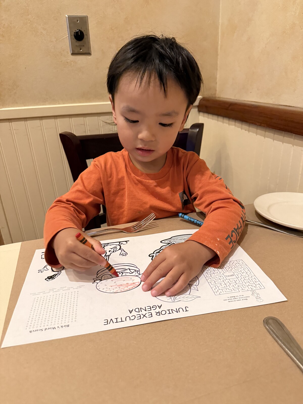 Jichang coloring with crayons at Birk's Restaurant while waiting for steak