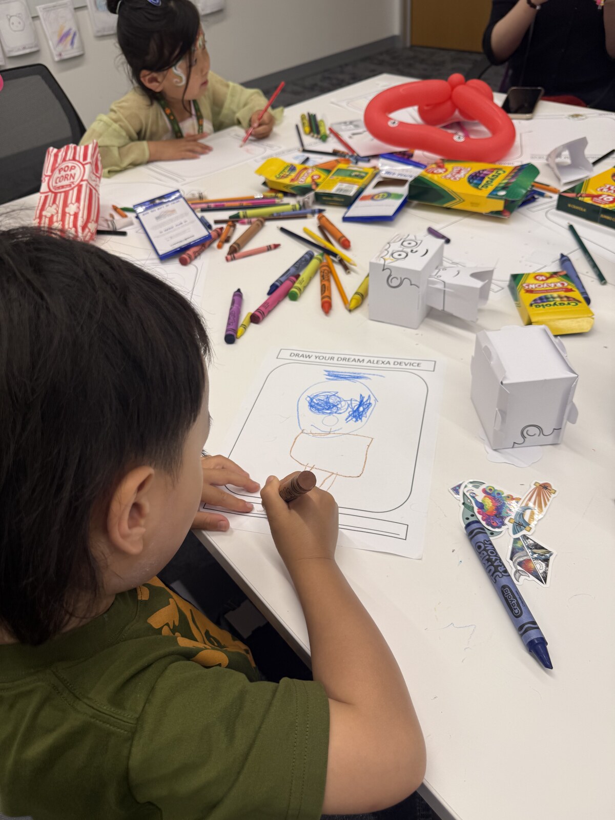 Jichang drawing a person on a dream device activity sheet