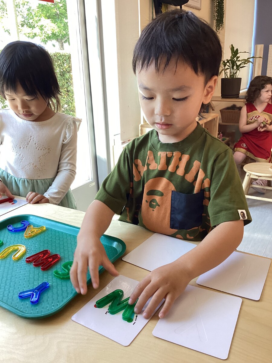 Jichang matching uppercase letters to lowercase letter cards in class