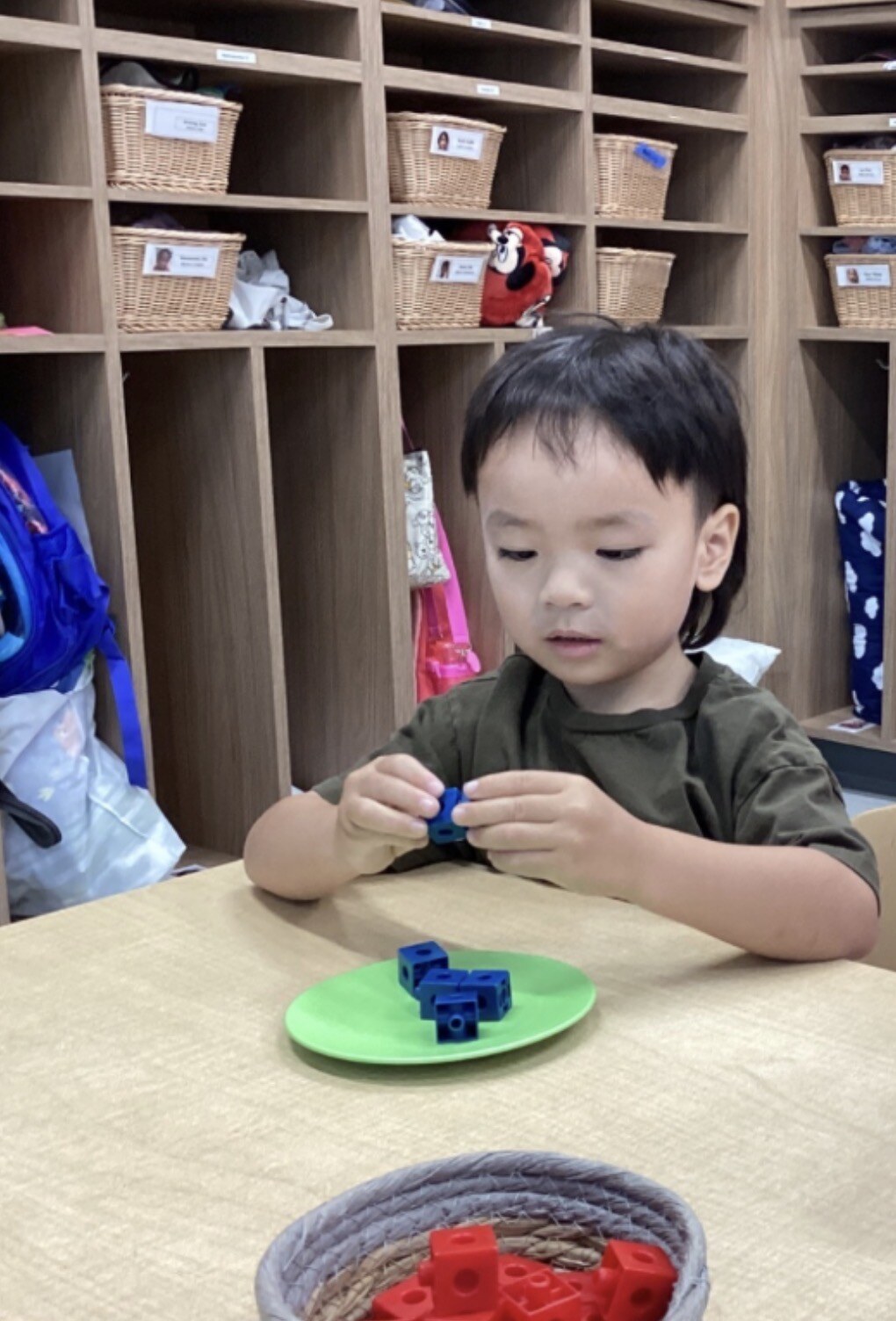 Jichang practicing ten towers with cubes at Bright Horizons