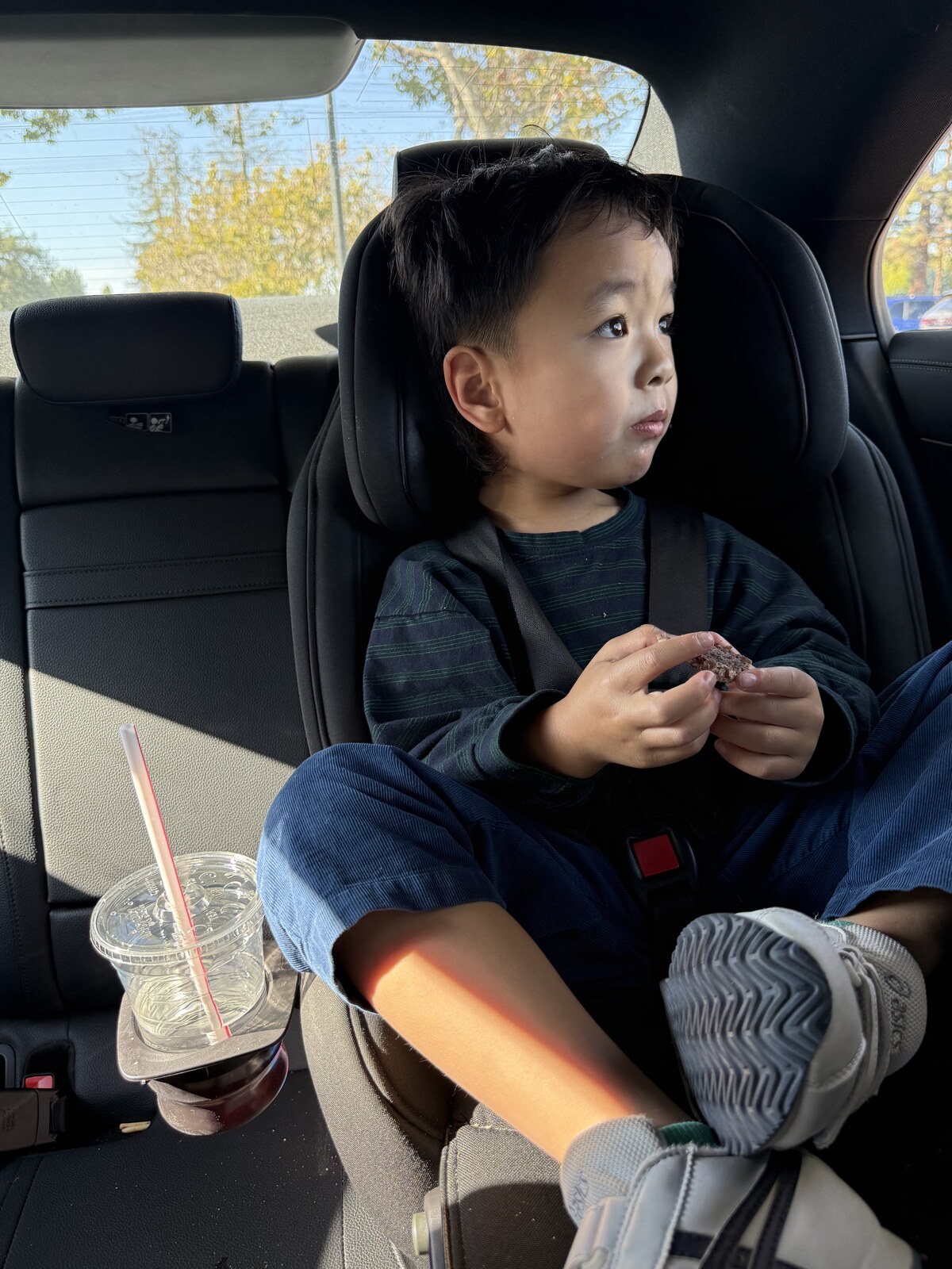 Jichang eating an IN-N-Out burger in the car on the way to the gym