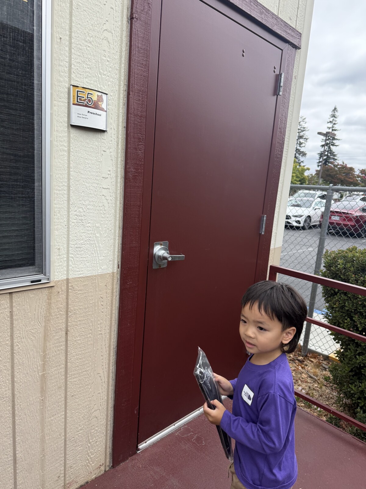 Jichang standing outside the Challenger School E5 classroom door