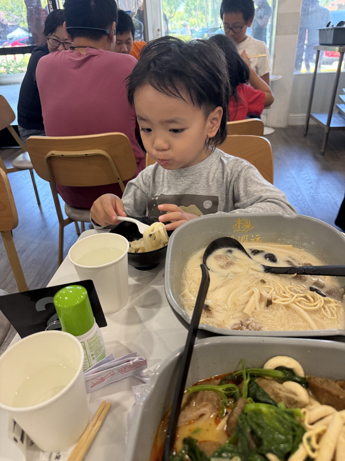 Jichang eating udon, beef, and mushrooms at YGF Malatang