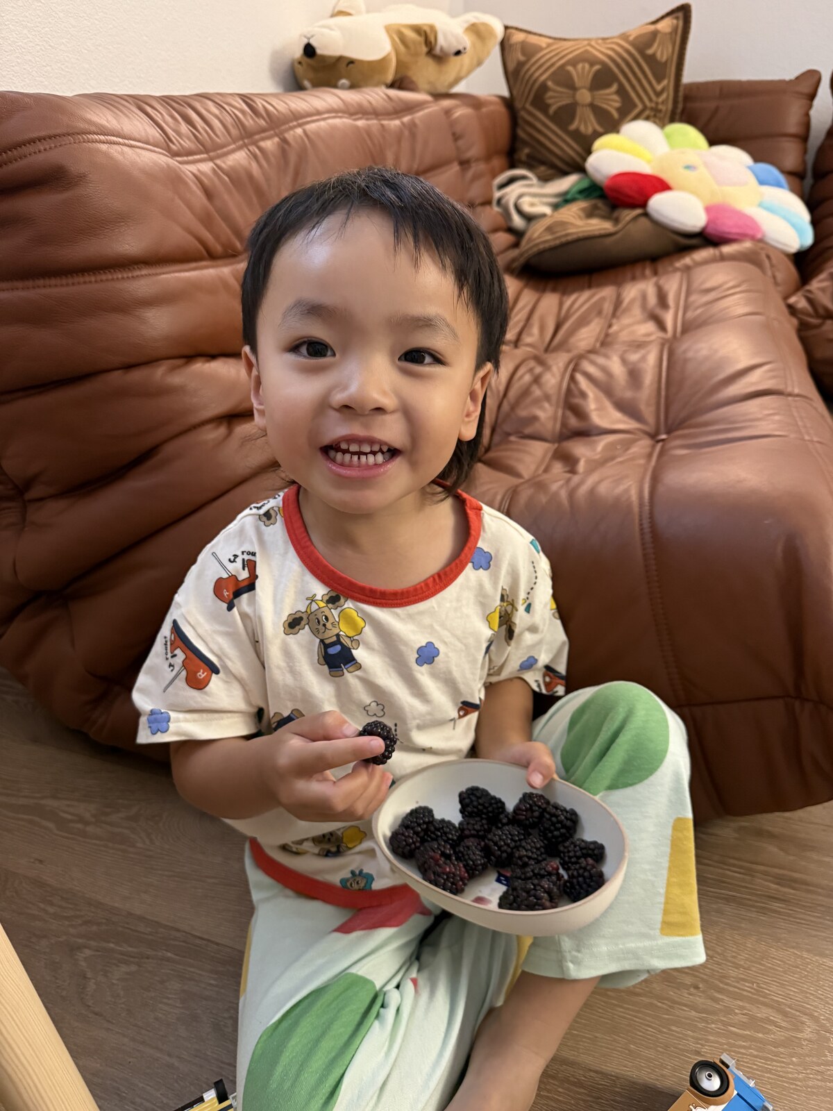 Jichang smiling with a bowl of blackberries at afternoon tea time
