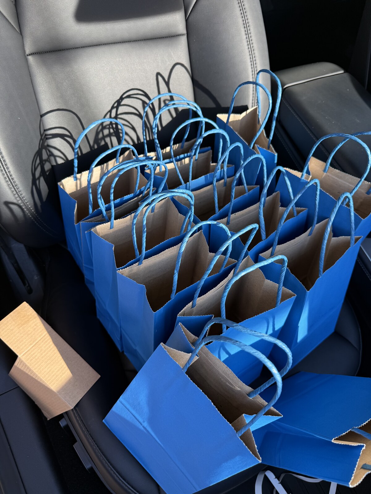 Blue goodie bags packed in the car for Jichang's classmates