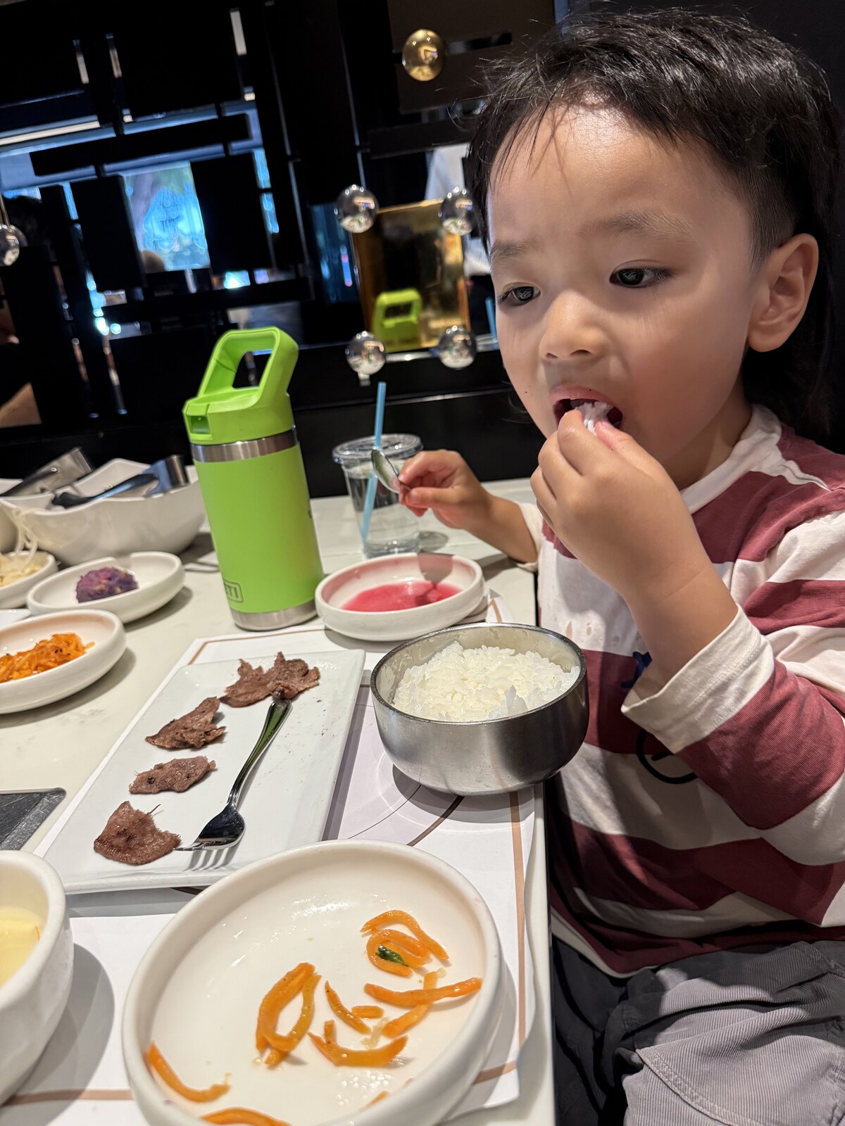 Jichang eating rice at a Korean BBQ dinner