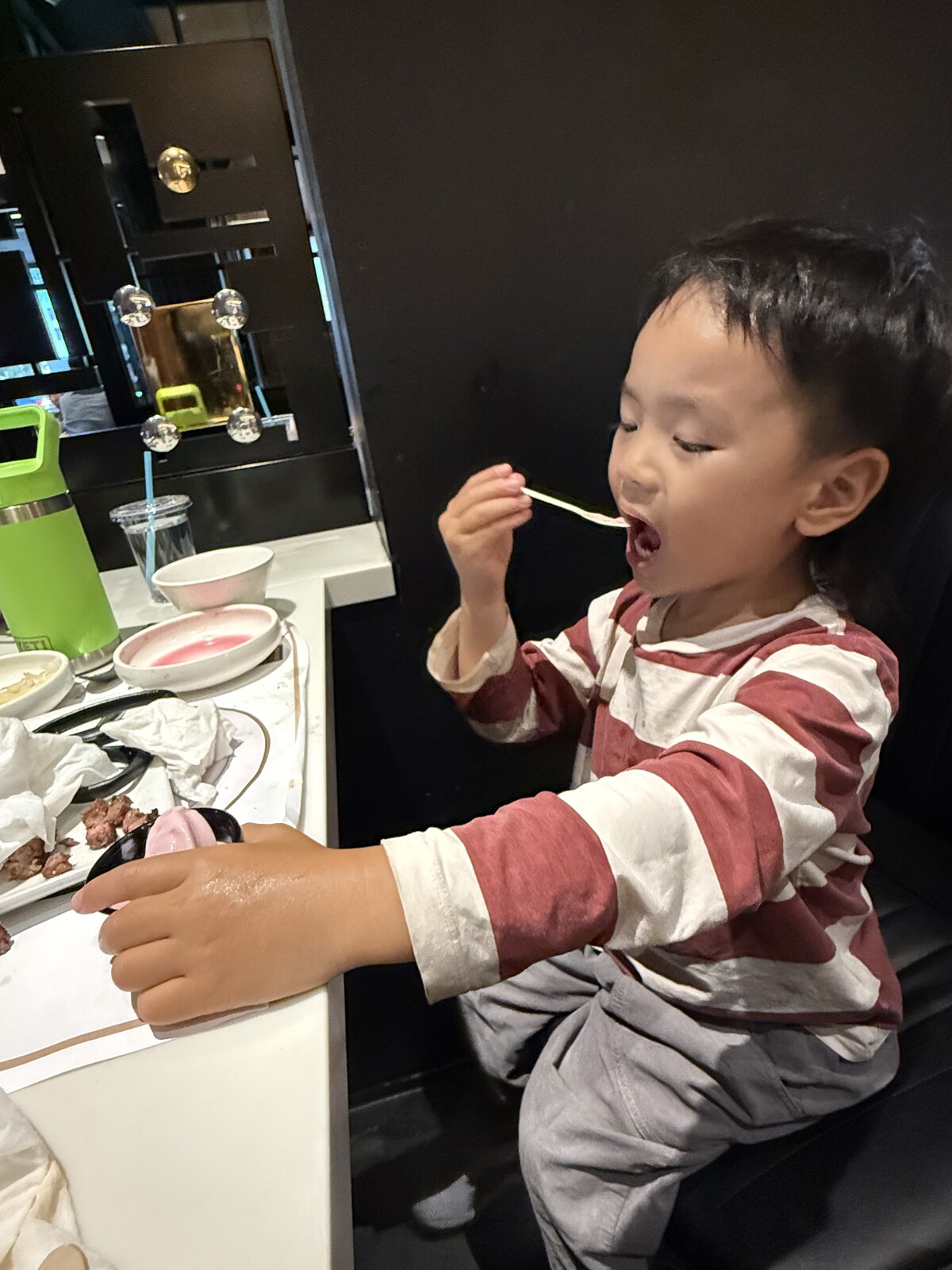 Jichang eating strawberry ice cream after Korean BBQ