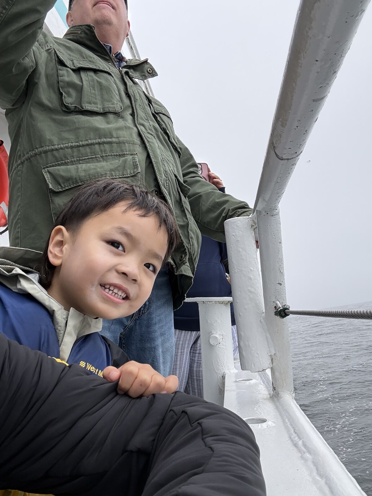 Jichang smiling on the deck of the whale watching boat