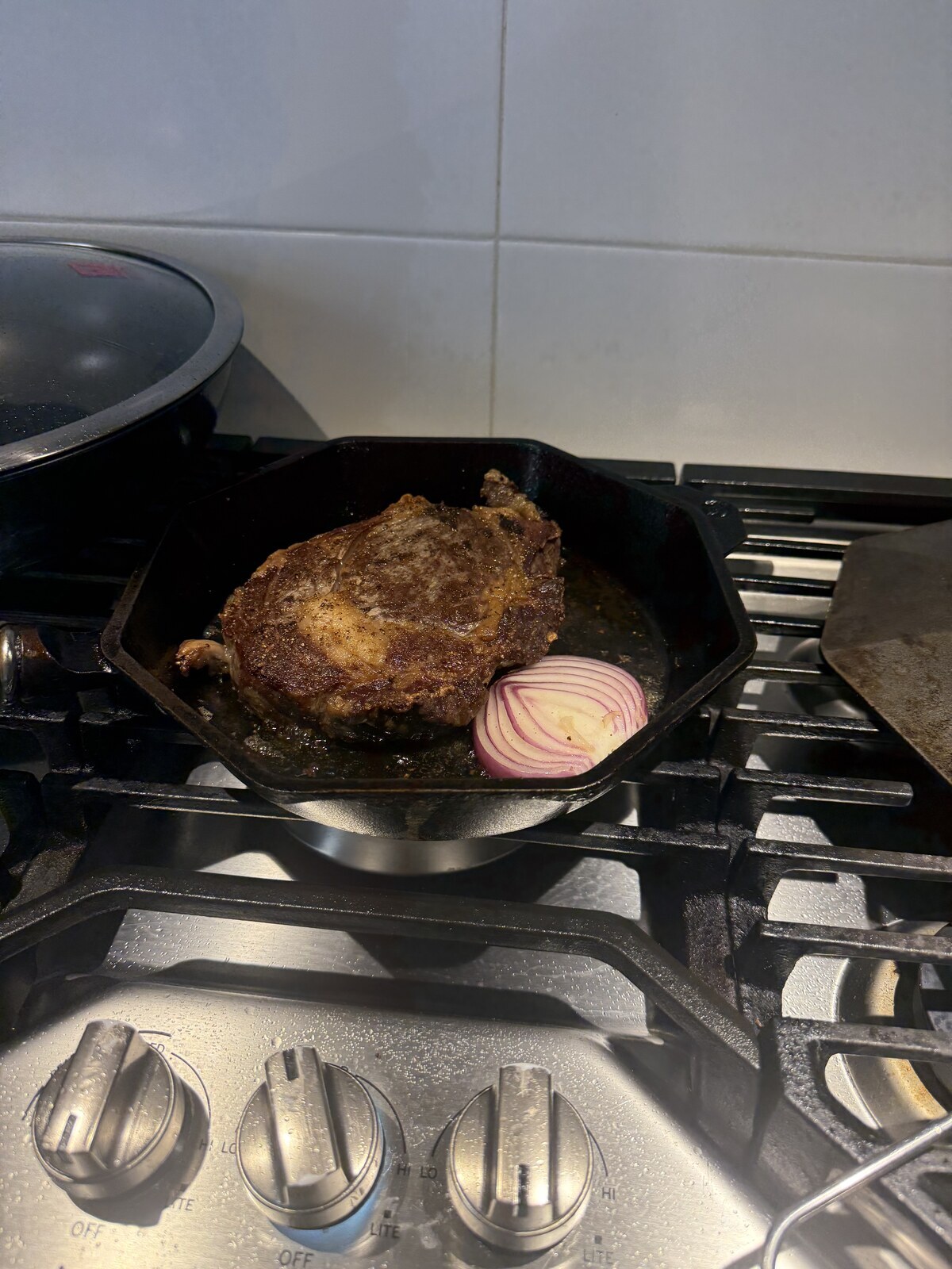 Steak and onion cooking in a pan